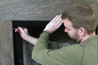 Place valance back in the center of your firebox and slide one valance extension outward until it meets the inner wall of firebox. Mark hole at the end of extension with a pencil.